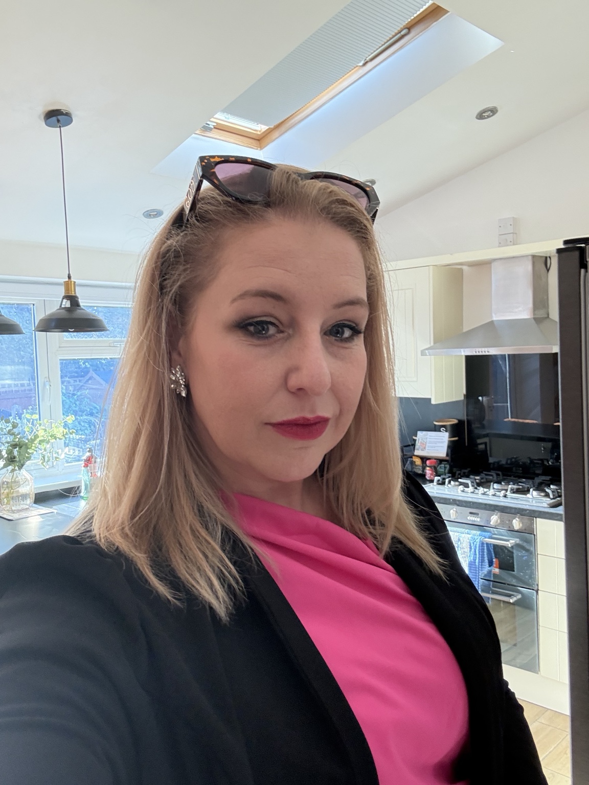 Jenna Clemence wearing a bright pink top and black jacket